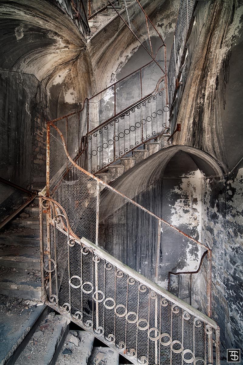 Staircase with gothic arches in an old water power plant in Italy