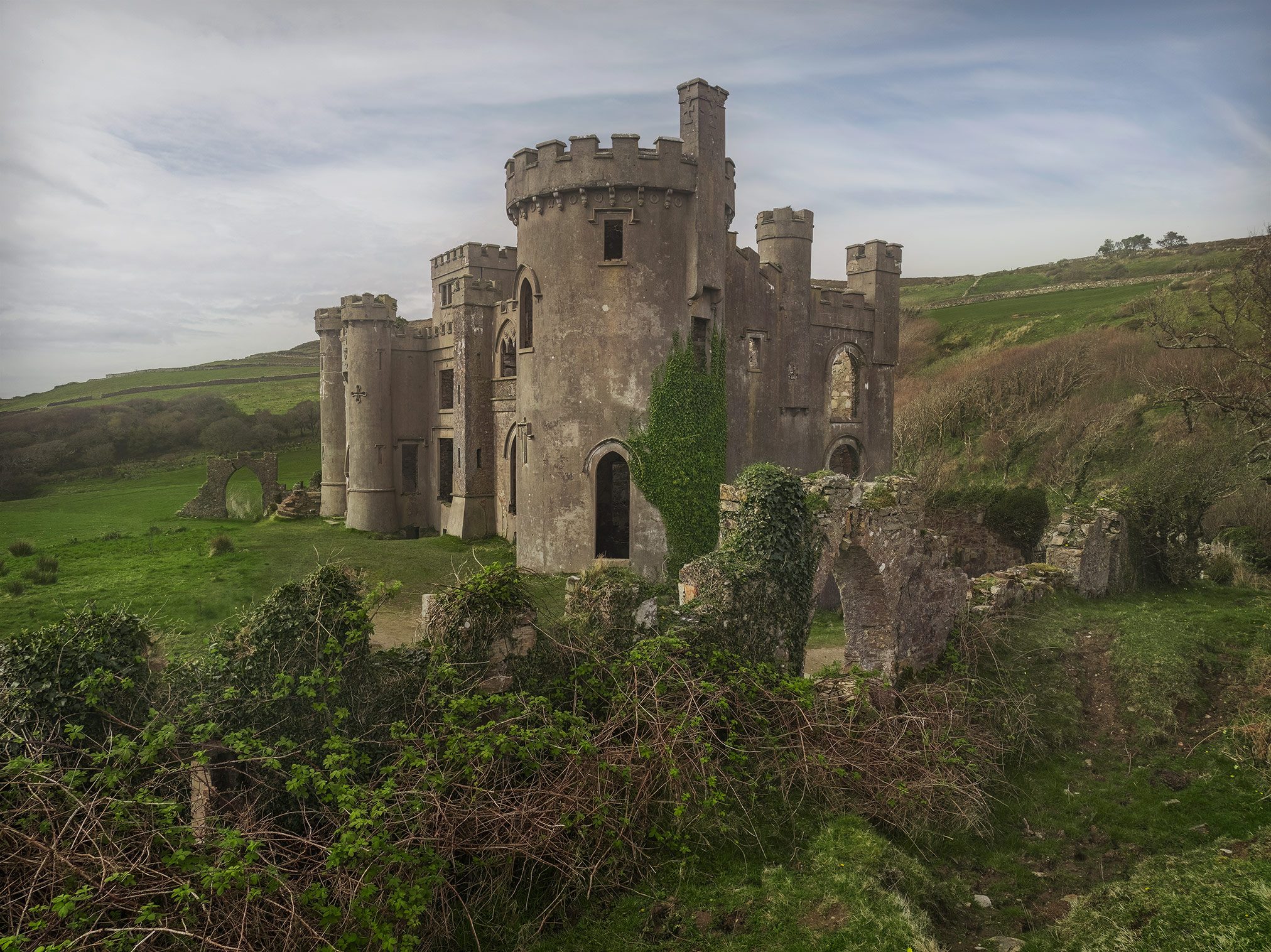 Castellated castle ruin covered in ivy in a national park, Ireland