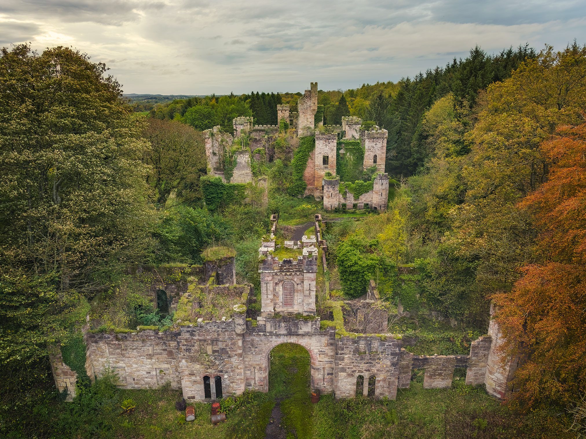 Ruin complex with an archway and tower in the forest, Scotland