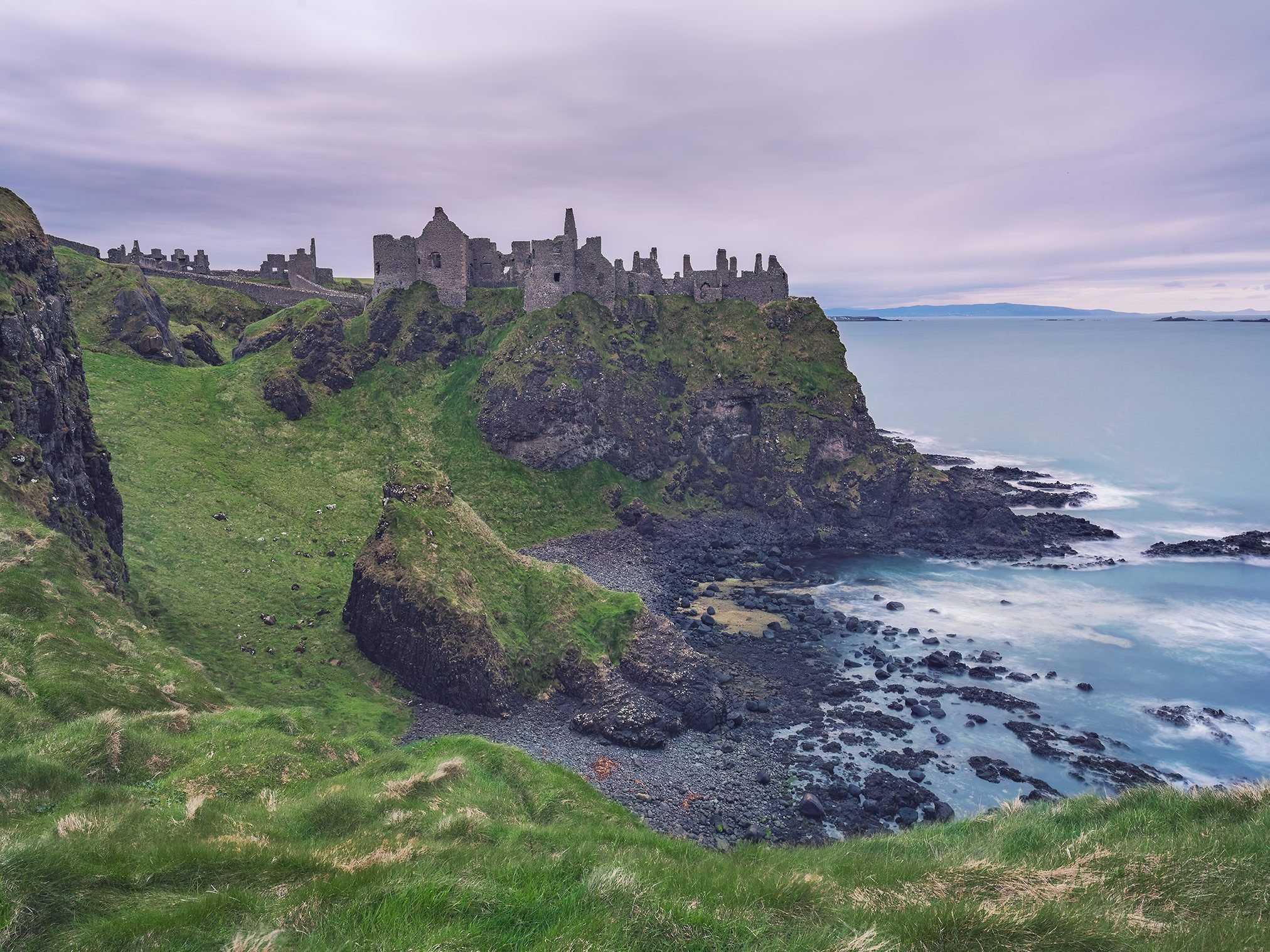 Extensive castle ruin on a cliff above the sea, Northern Ireland