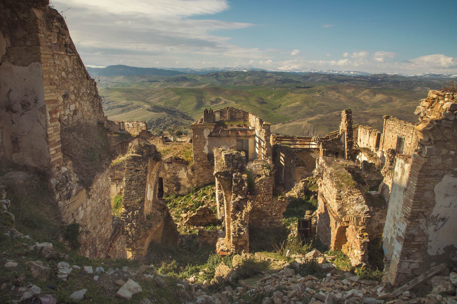 Abandoned hilltop town above wide rolling hills, Italy