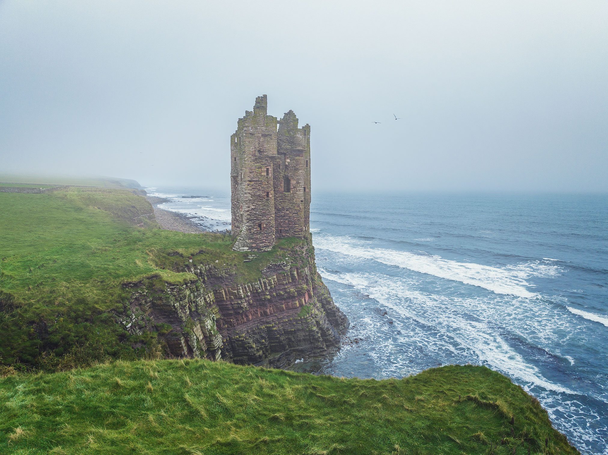 Round tower ruin right at the cliff edge, Scotland