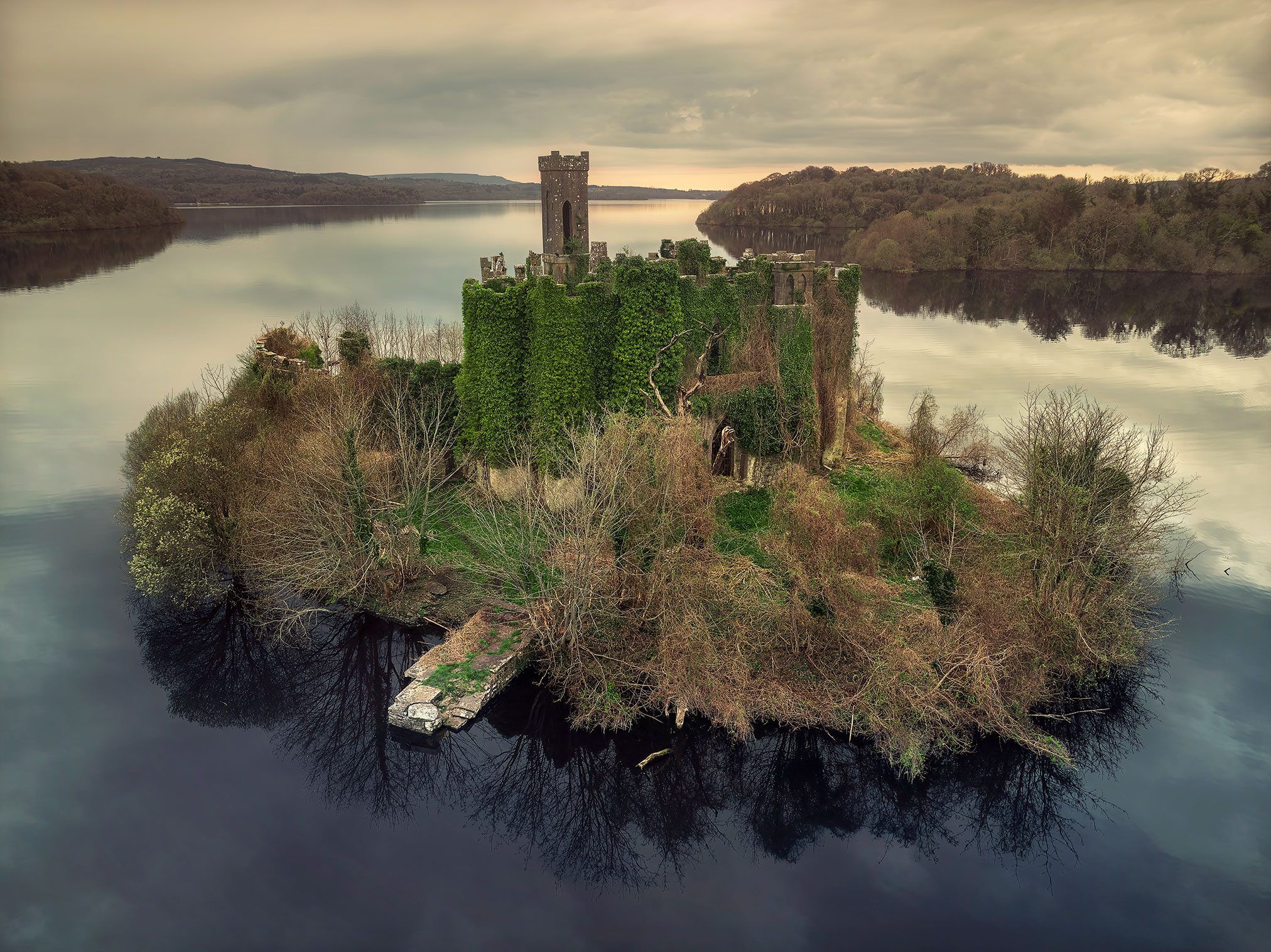 Ivy covered tower ruin on a small lake island, Ireland