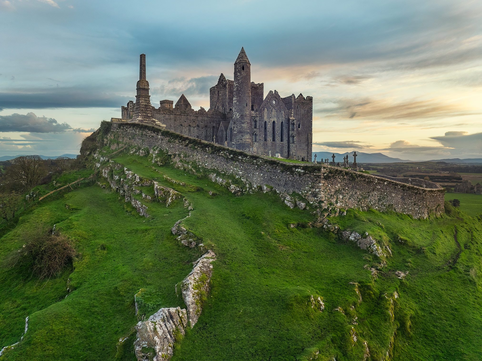 Ecclesiastical ruin complex along a hilltop wall, Ireland