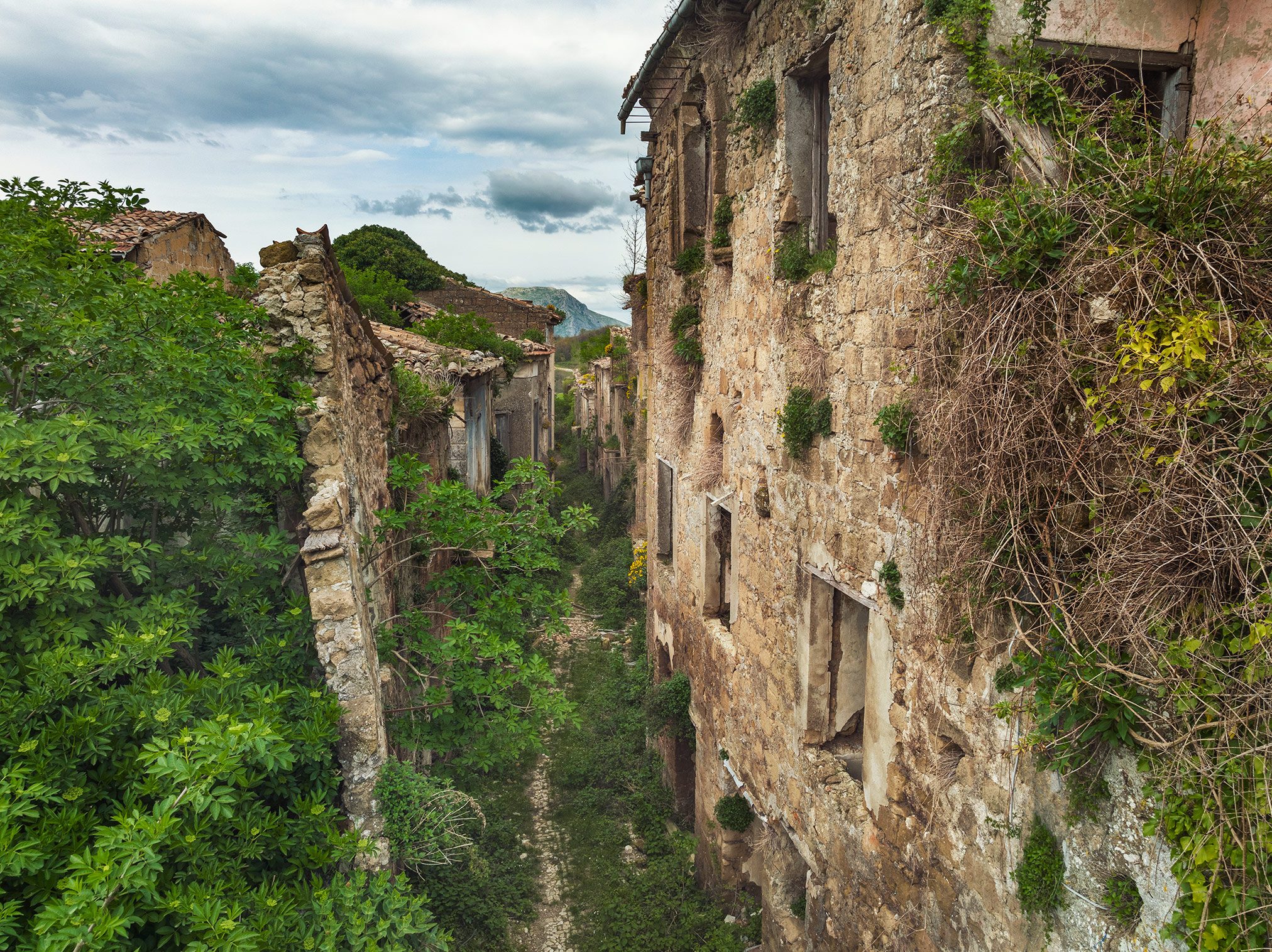 Abandoned lane between stone houses in a mountain village, Italy