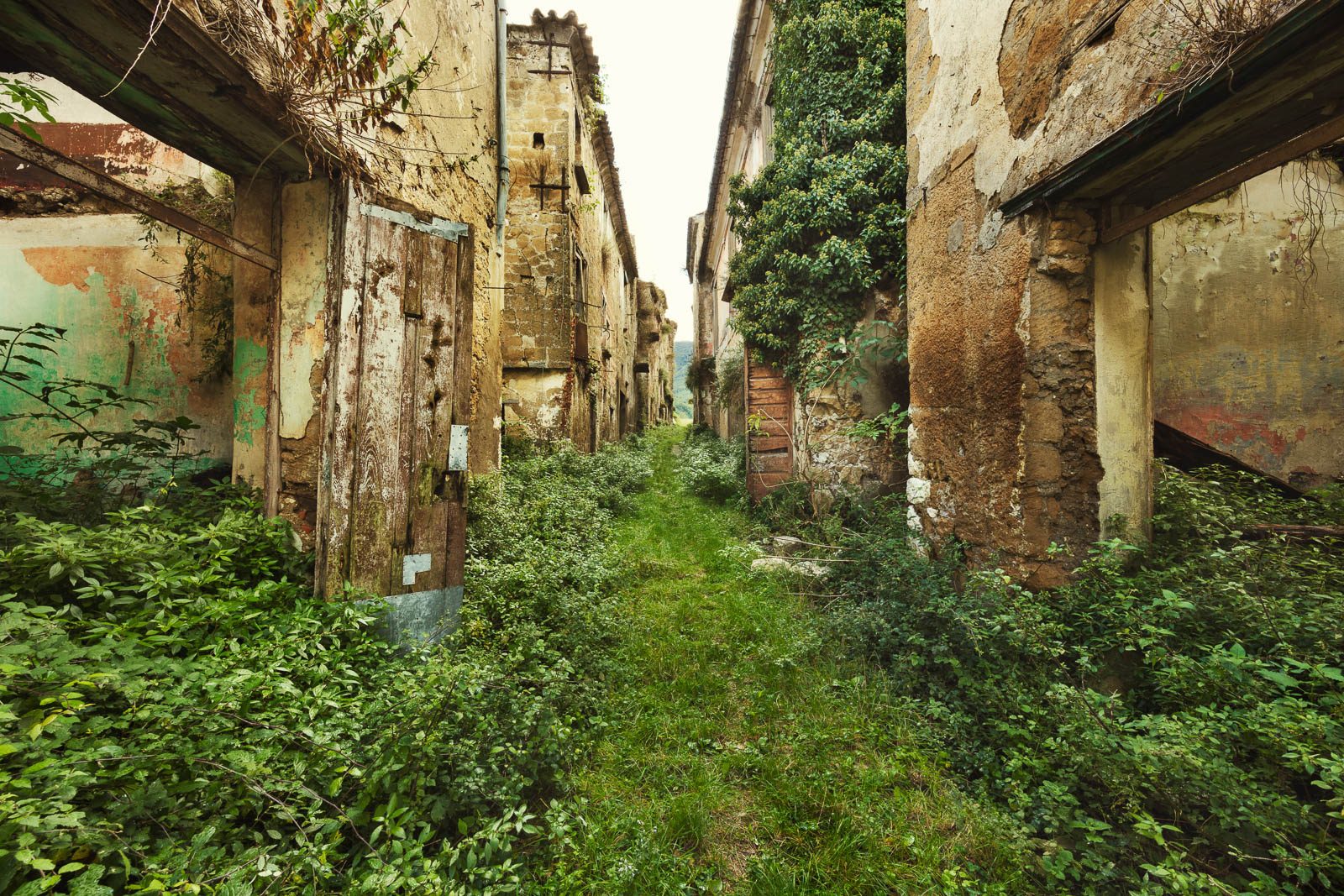 Decaying lane with peeling facades, Italy