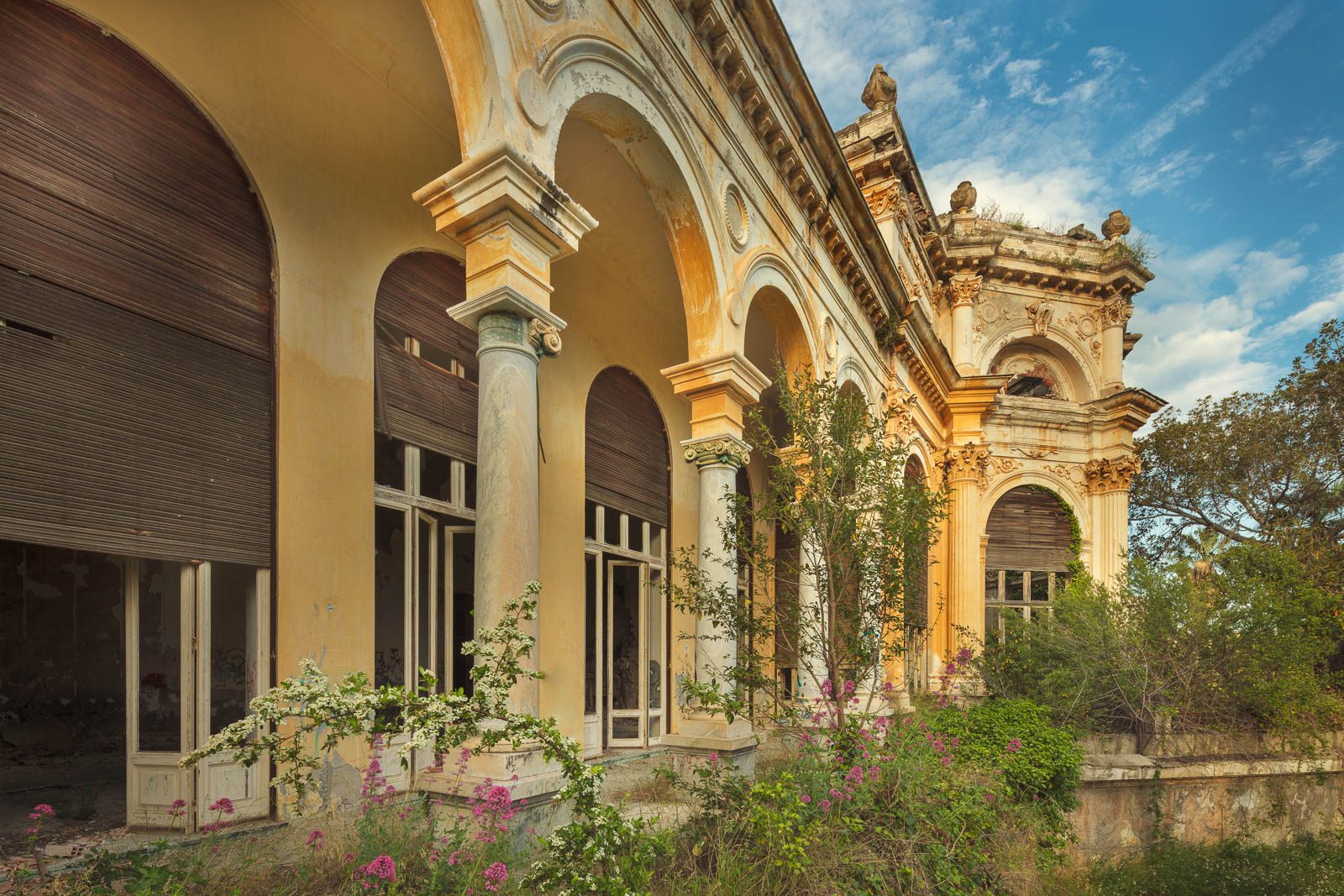 Marble hall with a symmetrical staircase and stained-glass window in a former casino in Italy