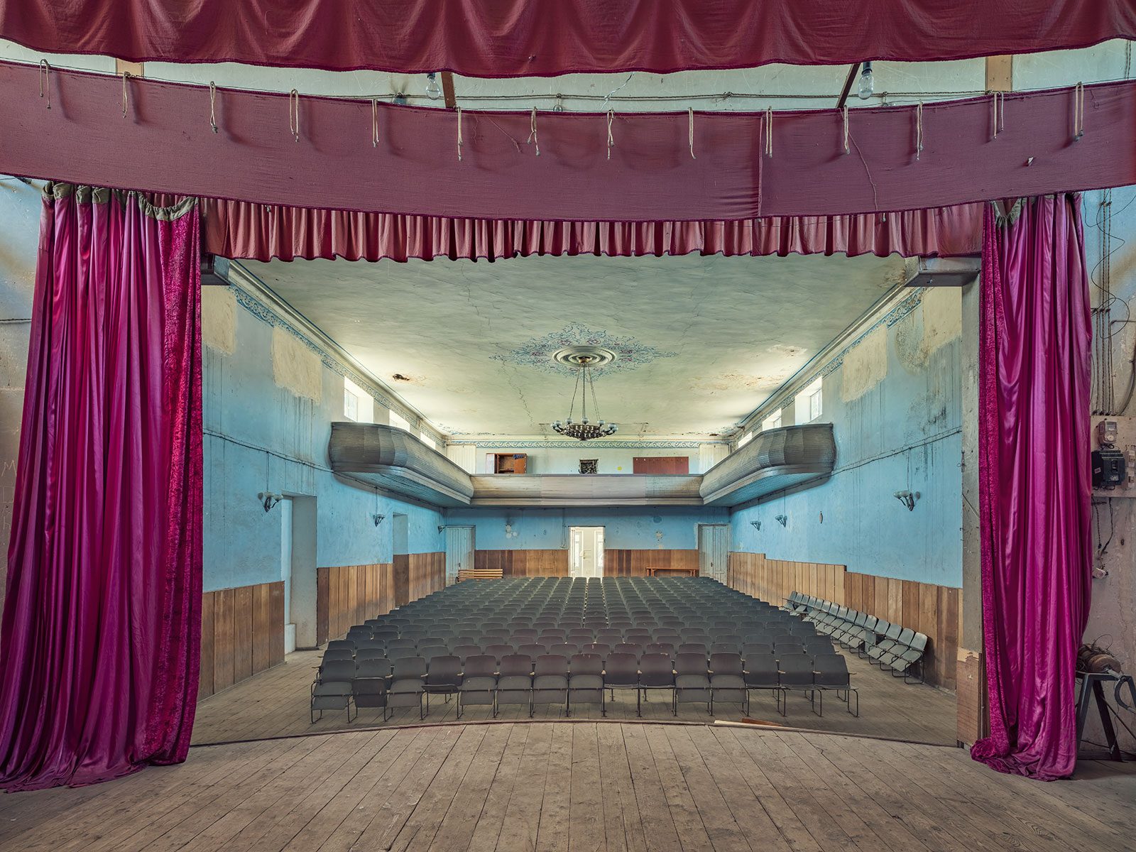 Theatre hall with turquoise walls and curved balconies in a house of culture in Georgia