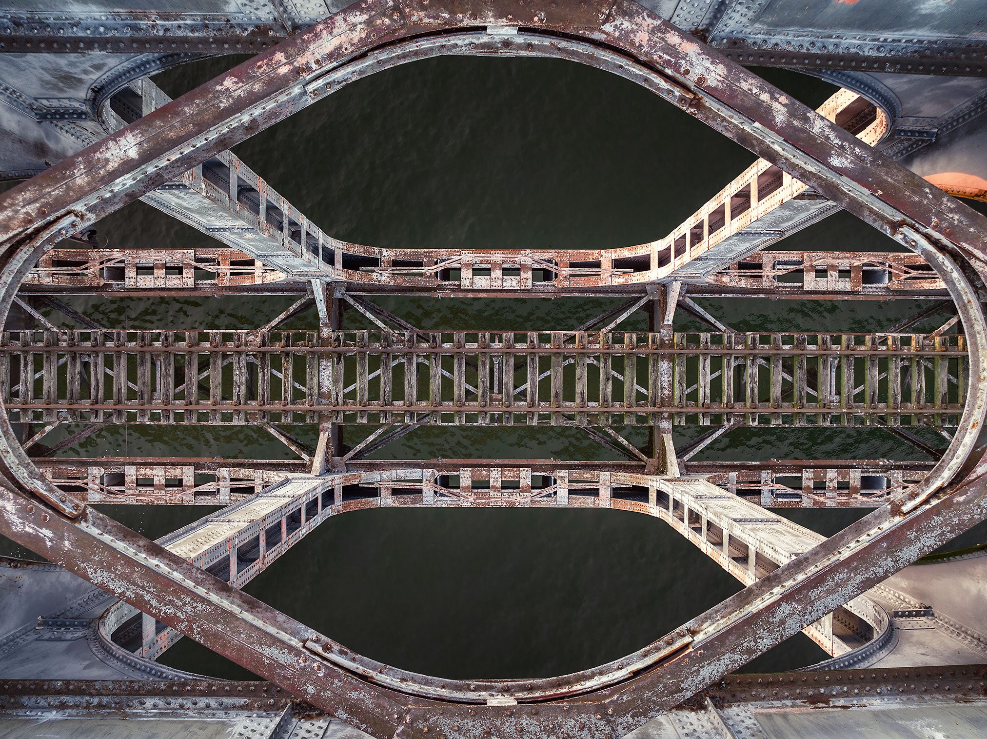 Steel trusswork of an abandoned railway bridge over a river in Belgium