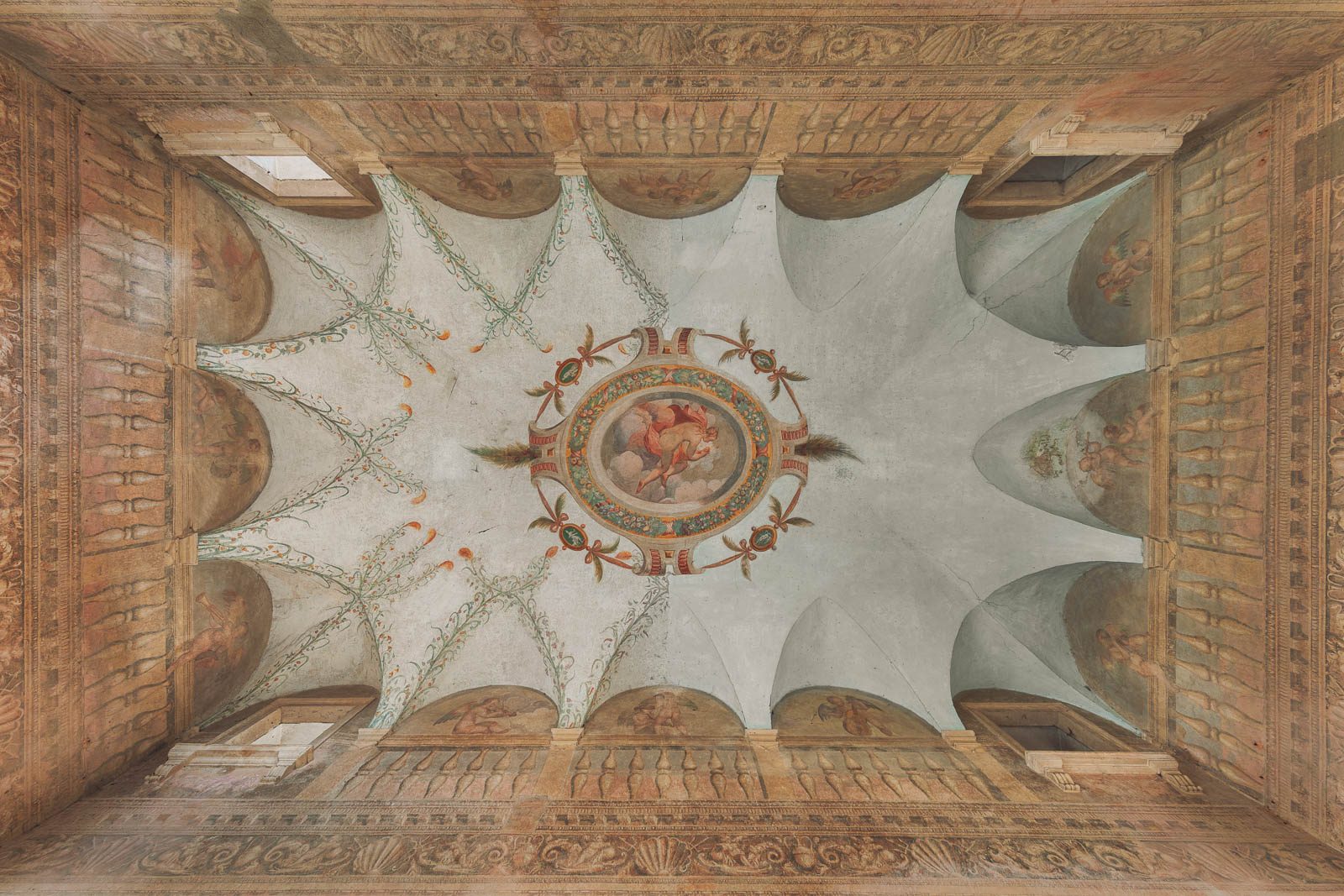 A frescoed vault with a putto medallion in a villa in Italy