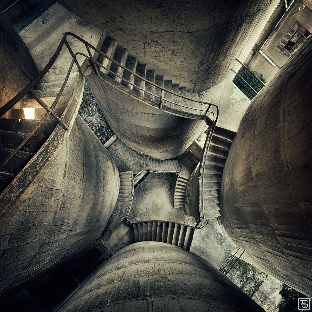 Stairways between concrete funnels in an abandoned factory in Italy