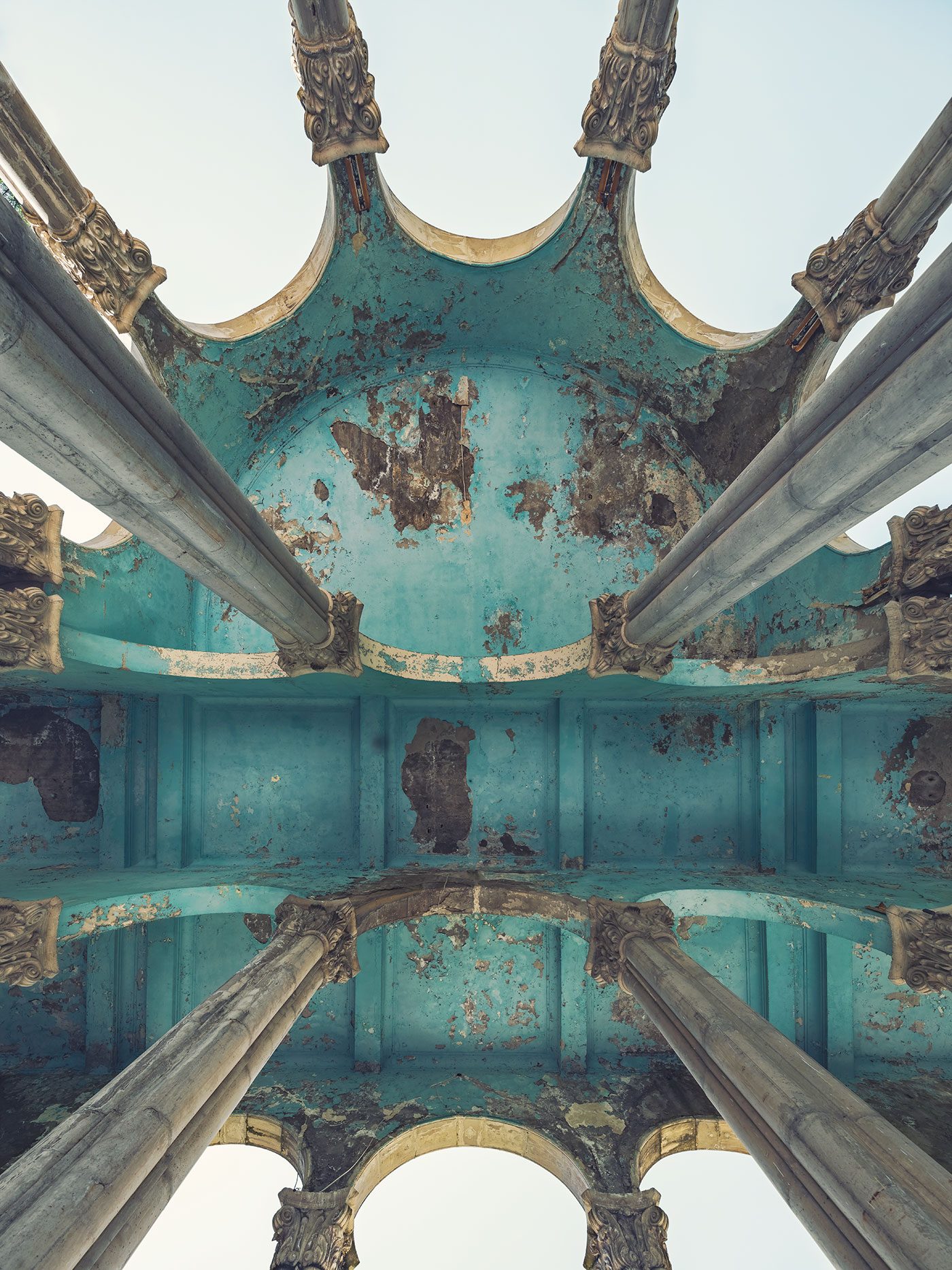 A teal, flaking ceiling dome in an abandoned hotel in Georgia