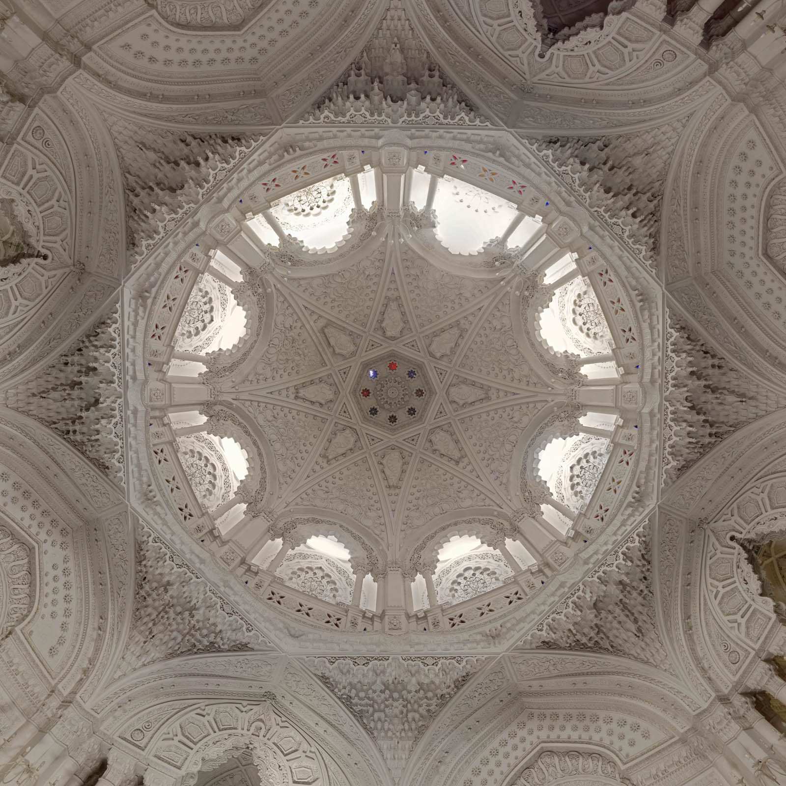 A richly decorated white stucco dome in Moorish style inside an abandoned castle in Italy
