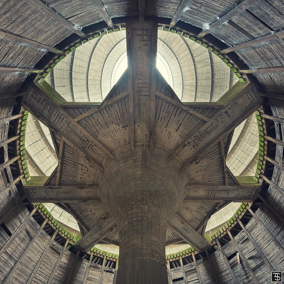 A wooden roof structure in the lower level of an abandoned cooling tower in Belgium