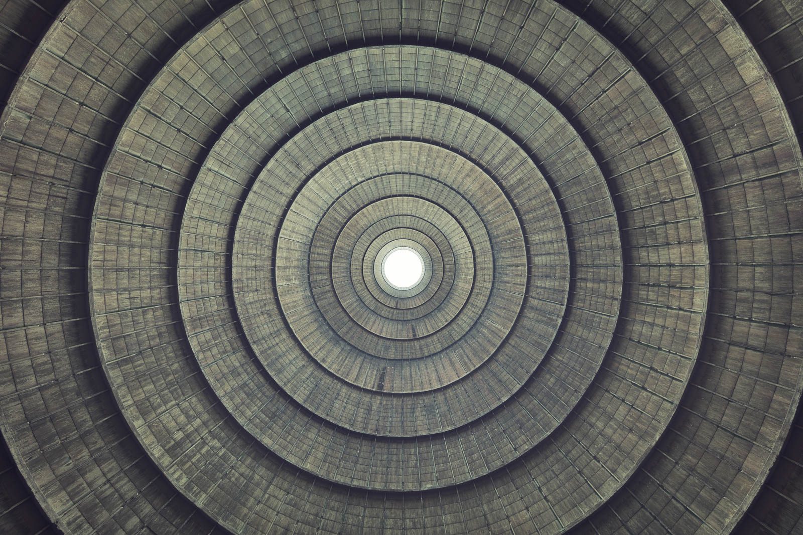 Concentric concrete rings inside an abandoned cooling tower in Belgium