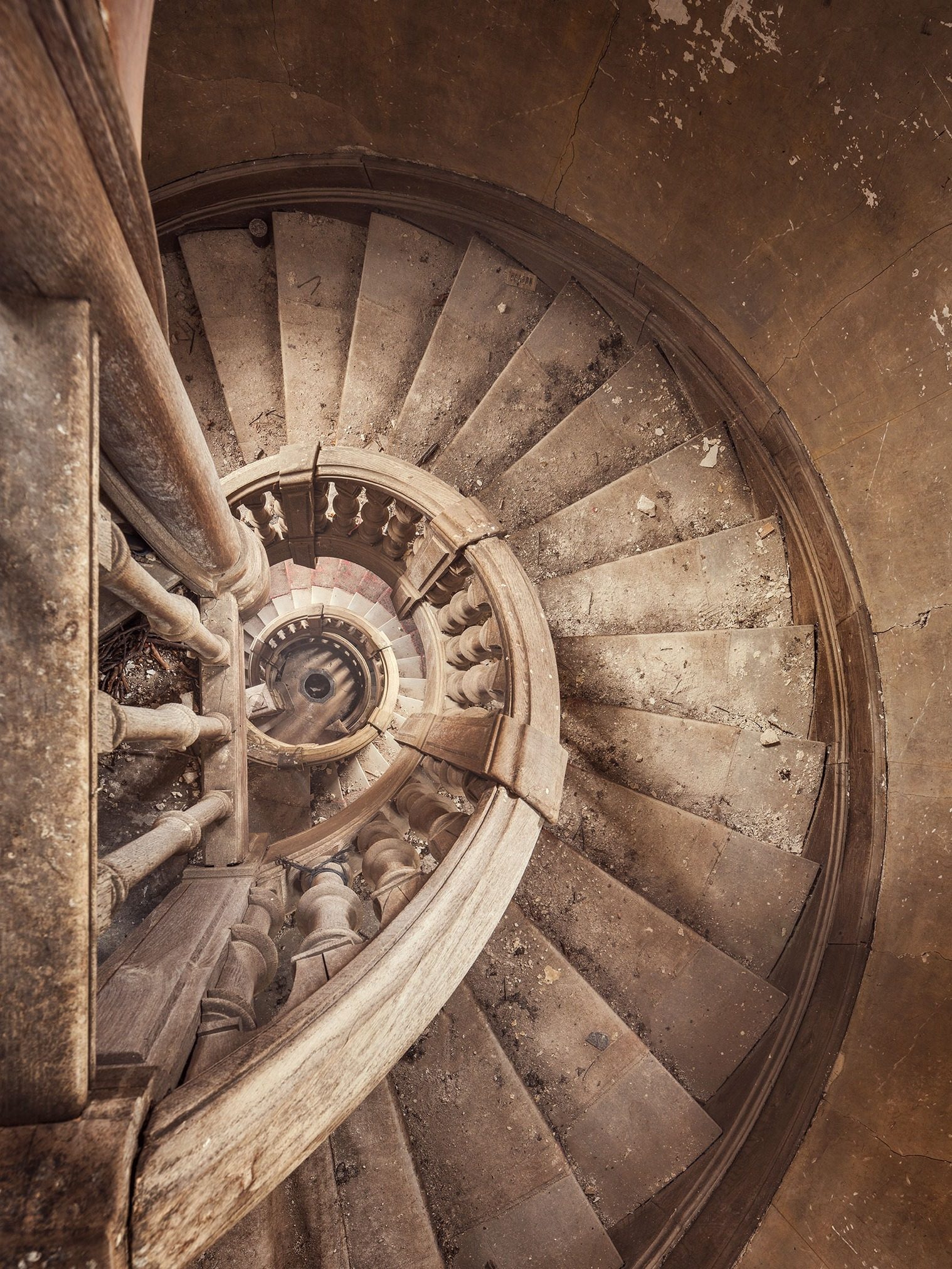 Wooden spiral staircase in an abandoned château in France