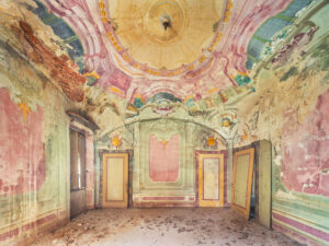 Pastel coloured frescoes inside an abandoned villa in Italy